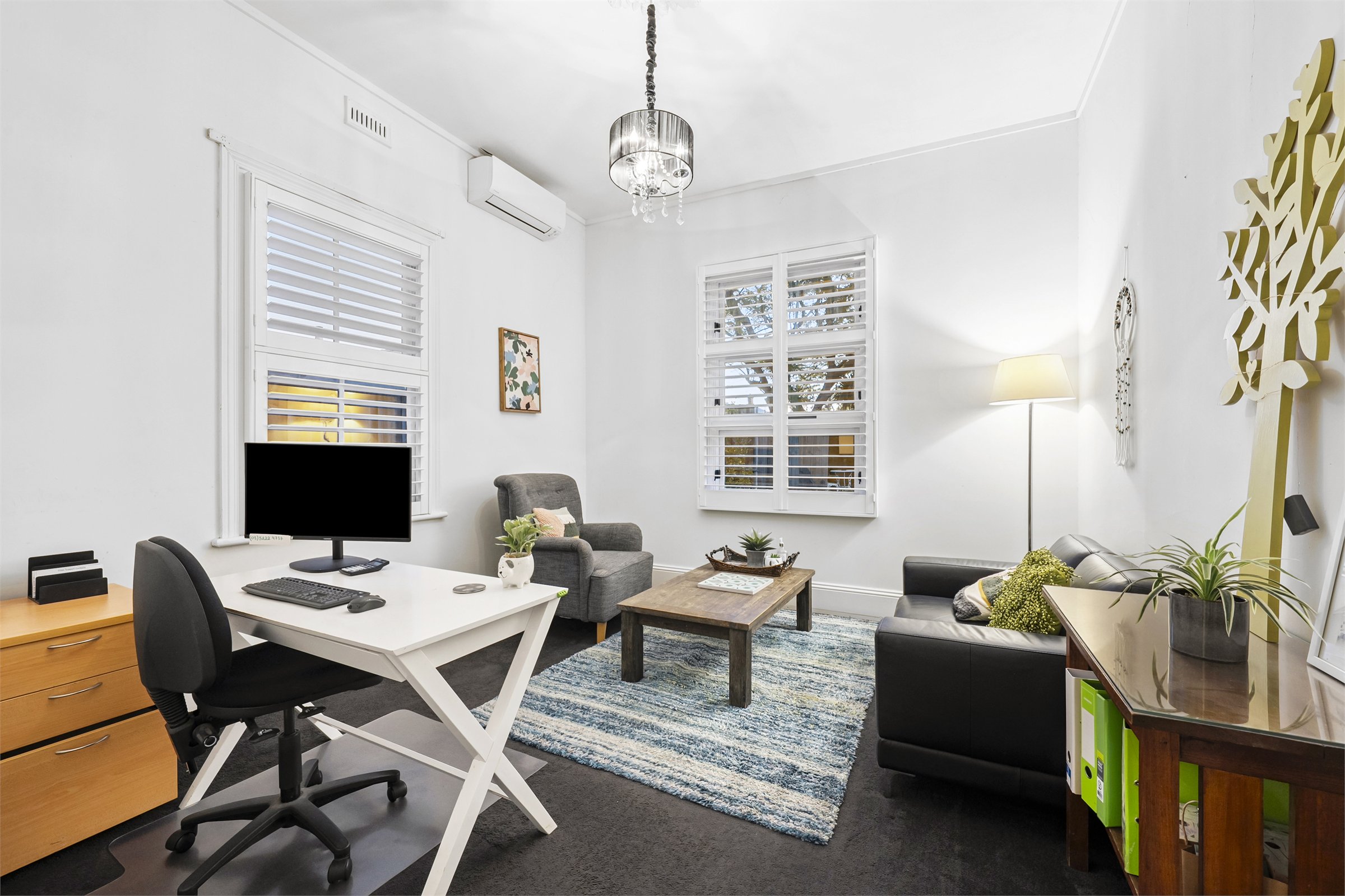 Workplace team meeting together in a bright office